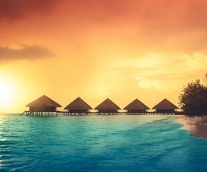 Sunset on Maldives island, water villas resort