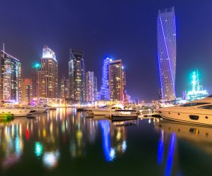 DUBAI, UAE - 31 MARCH 2014: Skyscrapers of Dubai Marina at night, UAE. Dubai Marina is a district in Dubai with artificial canal city who accommodates more than 120,000 people at Persian Gulf.